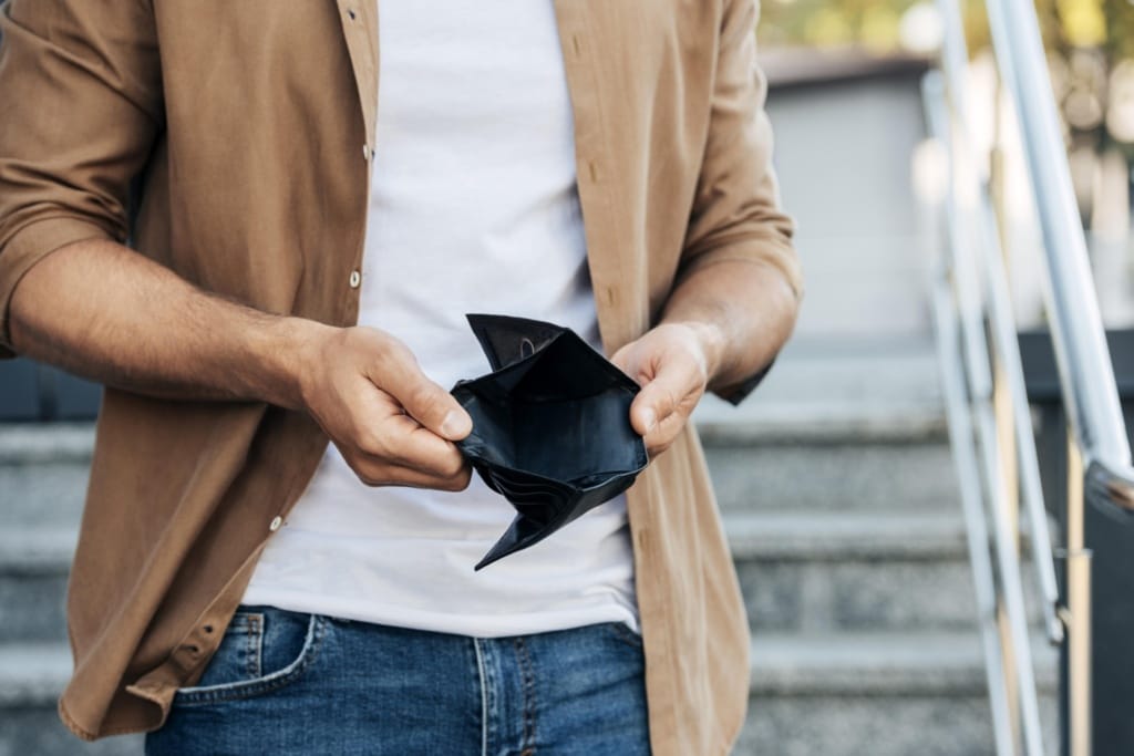 close up hands holding empty wallet 1920x1281