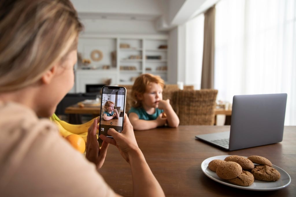 close up woman taking photos of kid 1920x1280